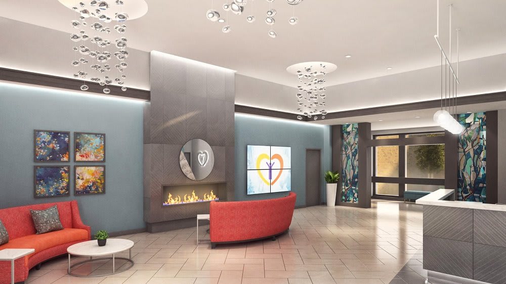A modern lobby with a fireplace, contemporary lighting, and comfortable seating.
