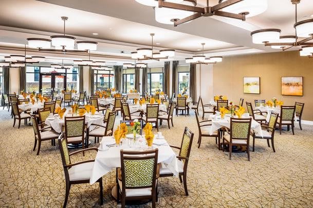 An elegant dining room with neatly arranged tables and chairs, ready for guests.