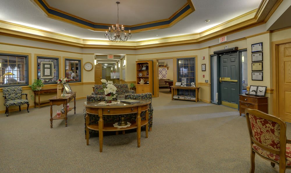 An elegantly decorated lobby with comfortable seating and a chandelier.