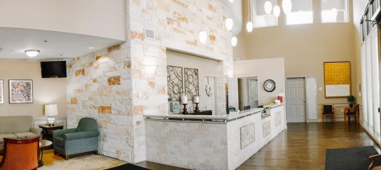 A modern reception area with a sleek counter and decorative elements.