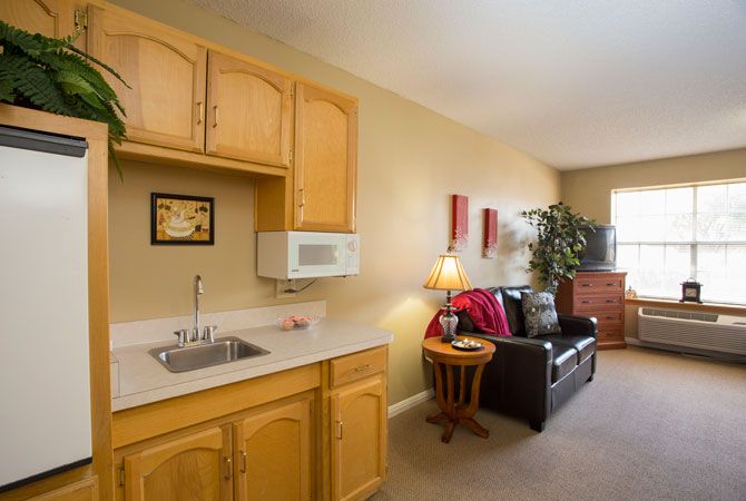 Cozy apartment with a kitchenette and small living area.