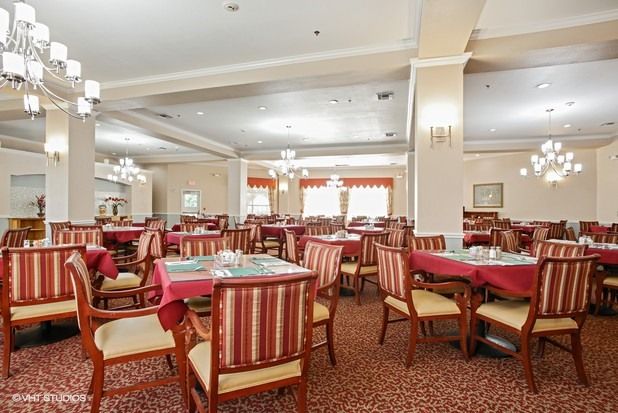 An empty dining room with neatly arranged tables and chairs.