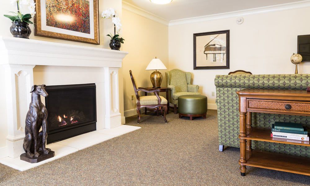 A cozy living room with a fireplace, comfortable seating, and tasteful decor.