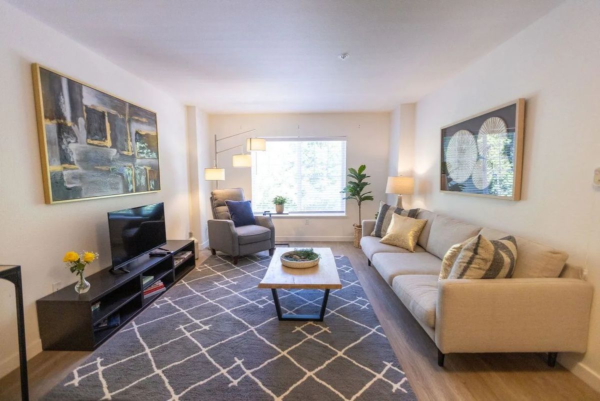 A modern living room with a cozy sofa, stylish coffee table, and ample natural light.