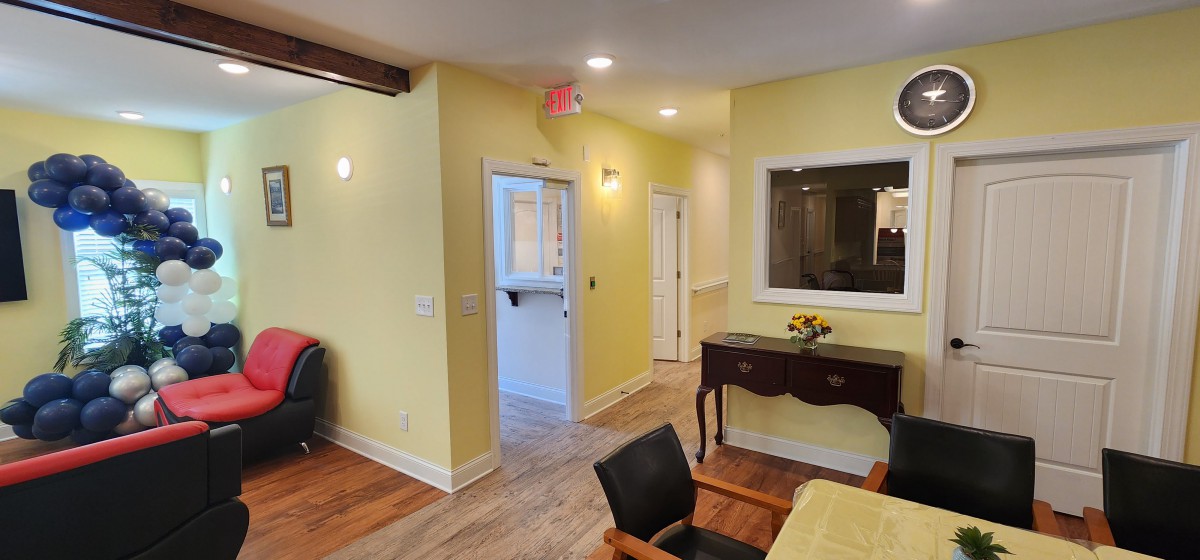 A warm and welcoming interior with yellow walls, a hallway, and elegant furniture.