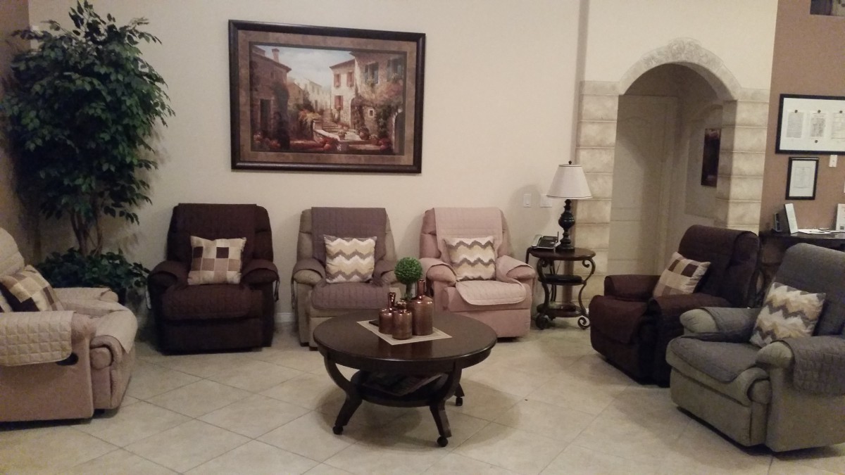 A cozy living room with multiple chairs, a coffee table, and wall art.