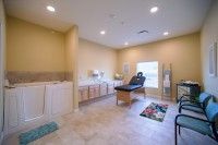 A serene spa therapy room with a massage table and calming decor.