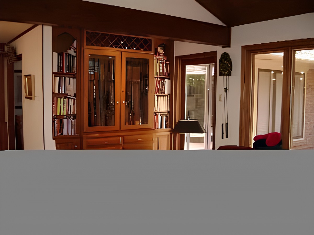 A cozy living room featuring wooden bookshelves and a cabinet.