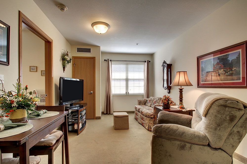 A cozy living room with a sofa, television, and warm lighting.