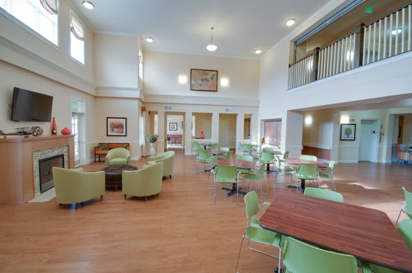 A spacious community center interior with tables and chairs arranged for gatherings.