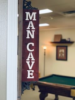 A cozy man cave featuring a pool table and vintage decor.