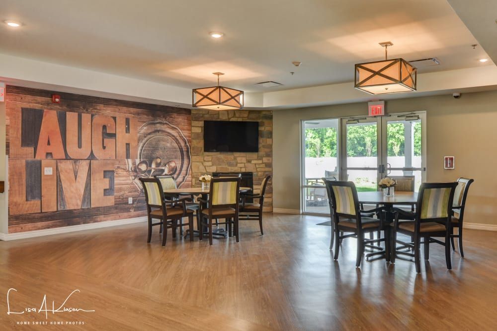 A modern dining area with a mural wall, featuring tables, chairs, and stylish lighting fixtures.