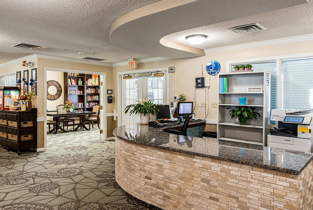 A welcoming reception desk in a well-decorated office space with a waiting area.