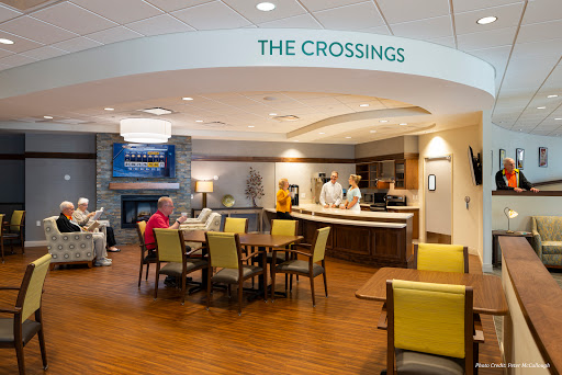 The inviting lobby area of The Crossings, featuring comfortable seating and a welcoming reception desk.
