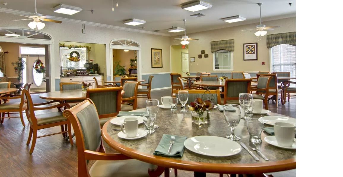 An elegantly set dining table in a spacious restaurant interior.