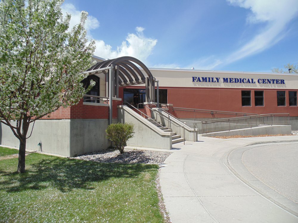Exterior view of a family medical clinic building under a clear blue sky.