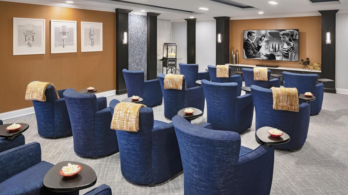 A modern seating area with blue chairs arranged in a conference style.
