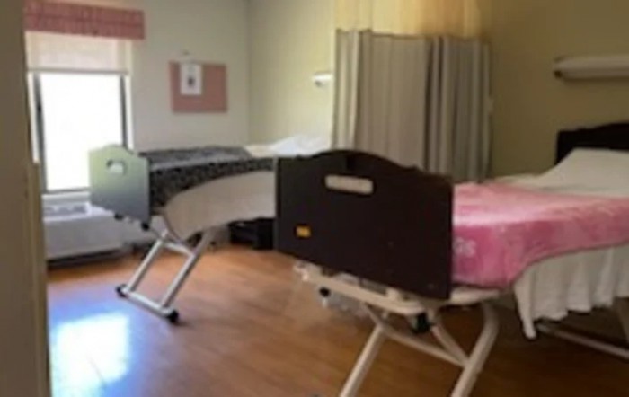 A hospital room with two medical beds.