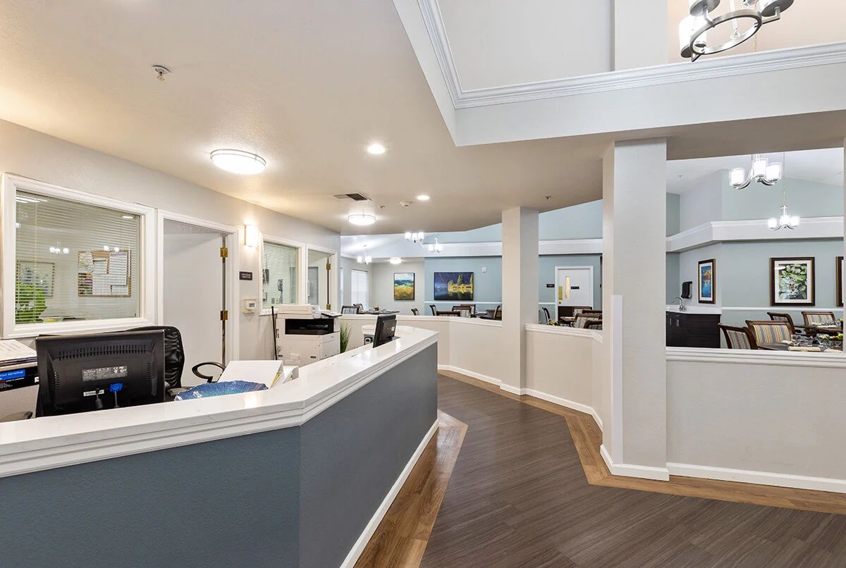 A modern office reception area with sleek design elements and multiple workstations.
