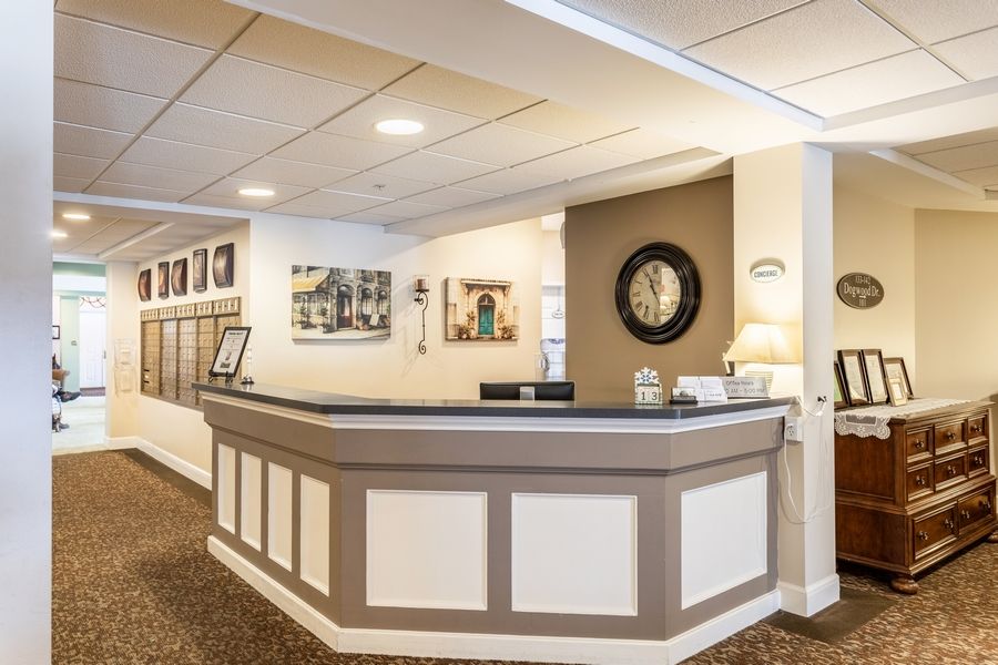 A welcoming reception desk with a clock and decorative elements.