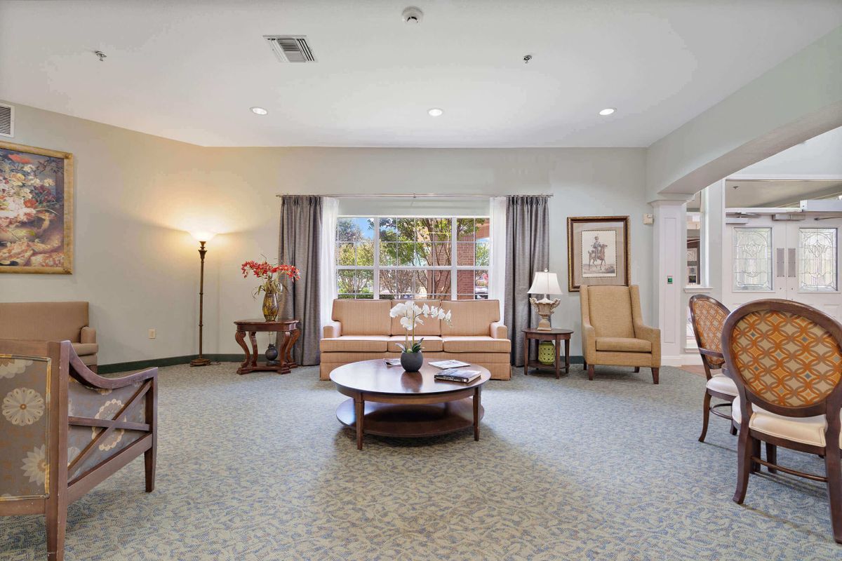 A spacious living room with comfortable seating and elegant decor.