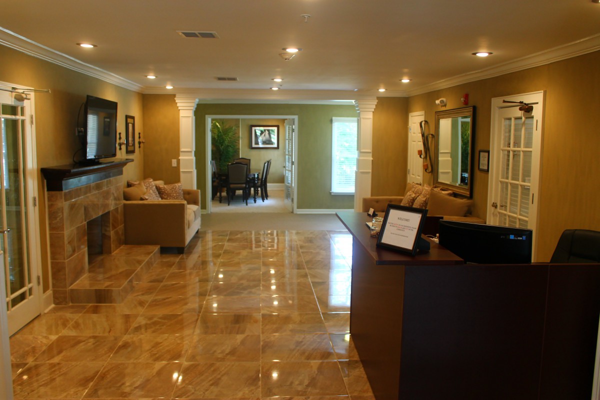 A spacious and well-lit living room with modern decor and tiled flooring.