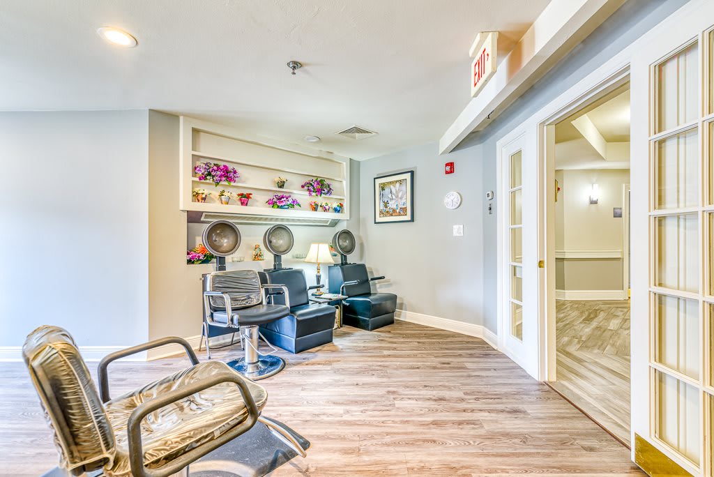 A welcoming salon interior with seating and hair drying stations.