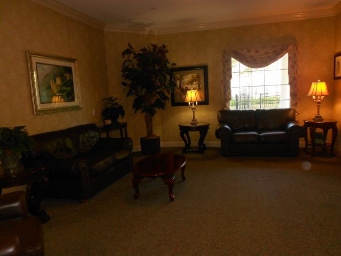 Cozy living room with sofas, a coffee table, and warm lighting.