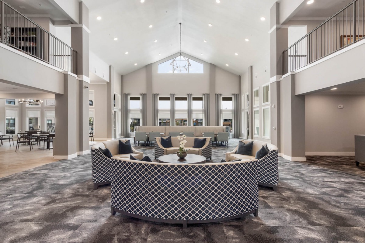 A modern lobby with stylish seating and a high ceiling.
