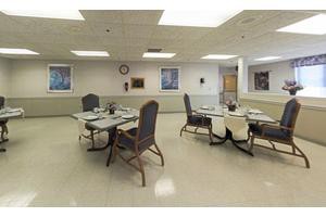 An empty dining room with tables and chairs arranged neatly.