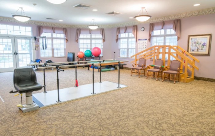 A rehabilitation room equipped with physical therapy tools and exercise equipment.