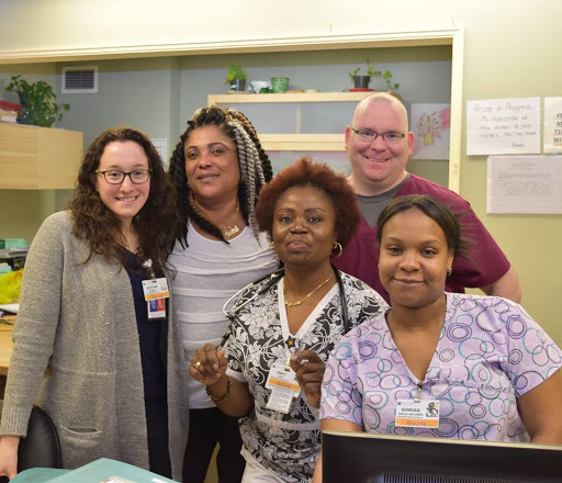 A diverse group of healthcare professionals posing together, showcasing teamwork and camaraderie.