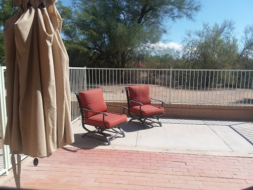 A serene outdoor space featuring two comfortable chairs on a sunny patio.