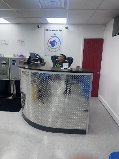 A reception area with a staff member relaxing at the counter.
