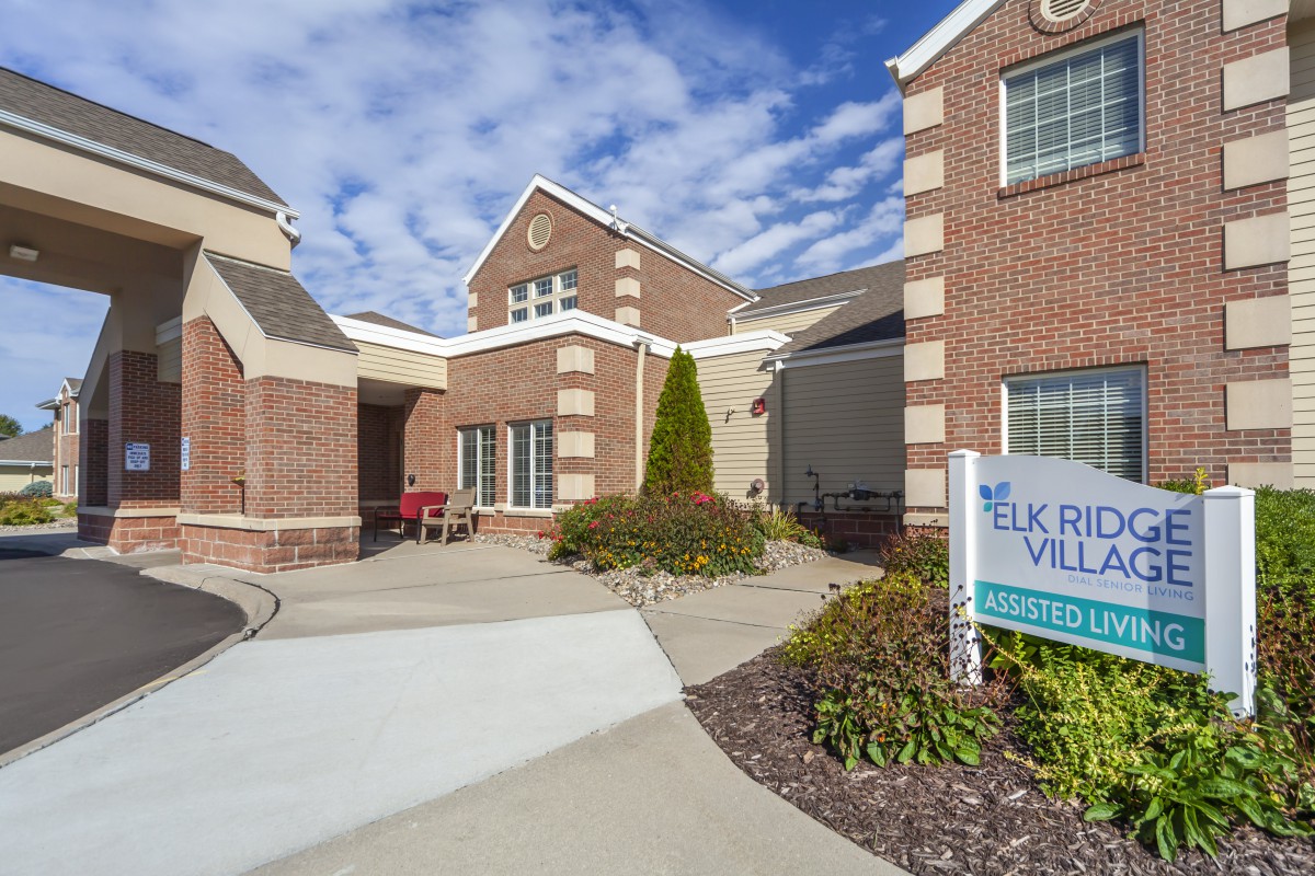 Exterior view of a senior living facility with brick architecture.