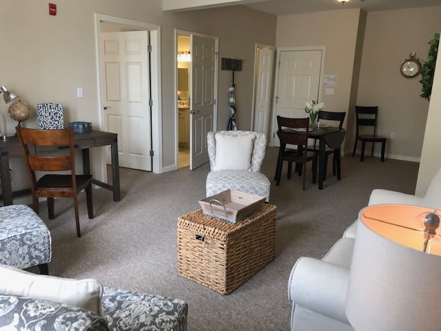 A cozy living room with comfortable seating and a dining area.