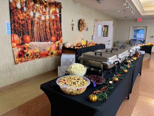 A beautifully arranged buffet table for a Thanksgiving celebration, adorned with autumn decorations.