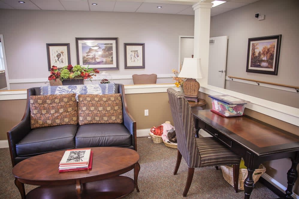 A cozy waiting room with comfortable seating and decorated walls.
