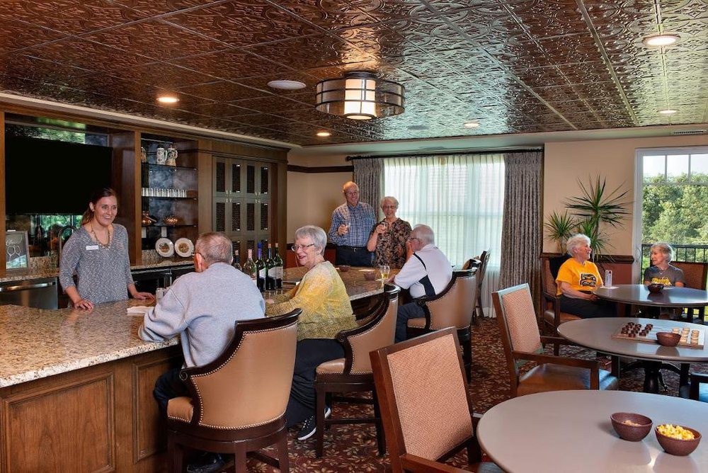 A group of seniors socializing in a community room.
