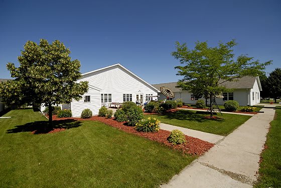 A suburban house with a well-maintained lawn and garden.