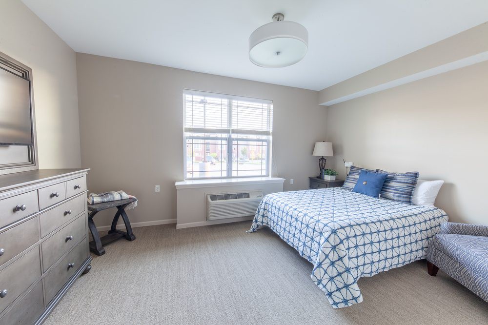 A clean and bright bedroom with a neatly made bed.