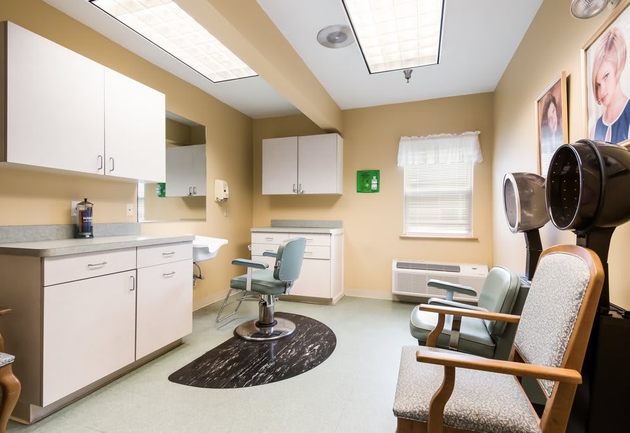 A well-organized examination room in a medical office, featuring clinical furniture and essential equipment.