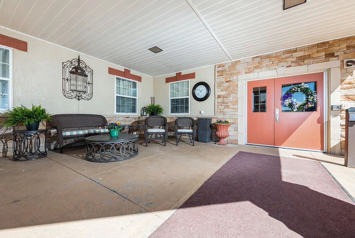 A cozy outdoor patio with comfortable seating and decorative elements.