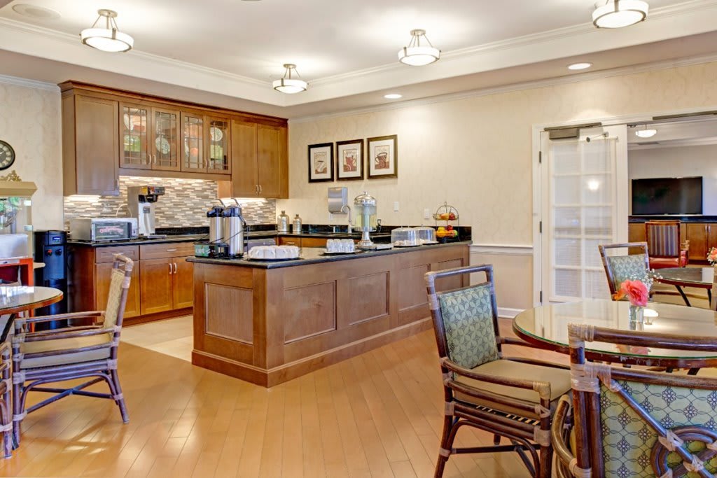A cozy kitchen cafe with wooden furniture and a well-organized counter area.