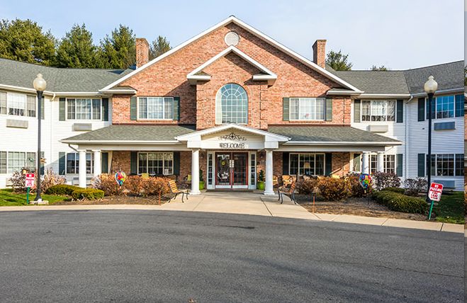 A two-story brick building with large windows and an inviting entrance.