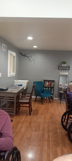 A cozy and modern interior featuring a comfortable seating area with a table and bookshelf.