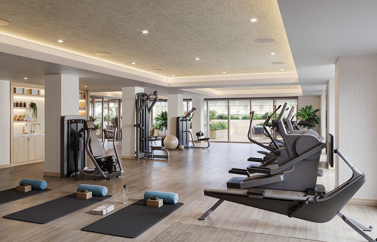 A spacious and modern gym equipped with treadmills, exercise machines, and yoga mats.