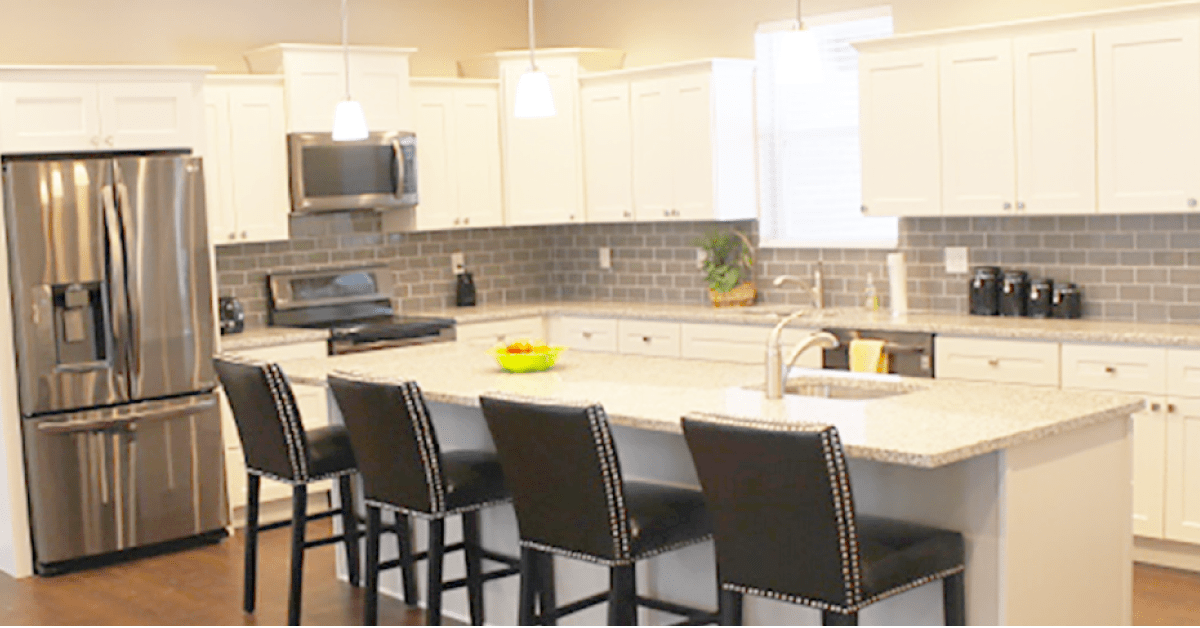 A modern kitchen with a spacious countertop and stylish bar stools.