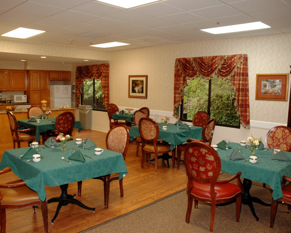 A cozy dining room with tables and chairs arranged in a warm, inviting setting.