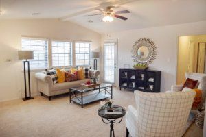 A cozy living room with comfortable seating, stylish decor, and ample natural light.
